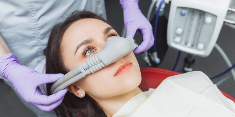 Dentist,Puts,Inhalation,Sedative,Mask,On,His,Patient. sedation dentist near me