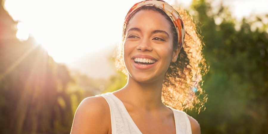 Portrait,Of,Beautiful,African,American,Woman,Smiling,And,Looking,Away teeth whitening near me