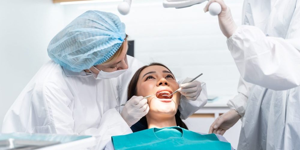 Caucasian,Dentist,Examine,Tooth,For,Young,Girl,At,Dental,Health root canals brentwood