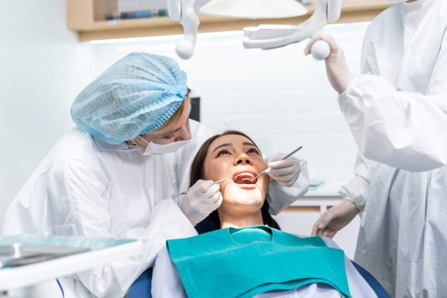 Caucasian,Dentist,Examine,Tooth,For,Young,Girl,At,Dental,Health root canals brentwood