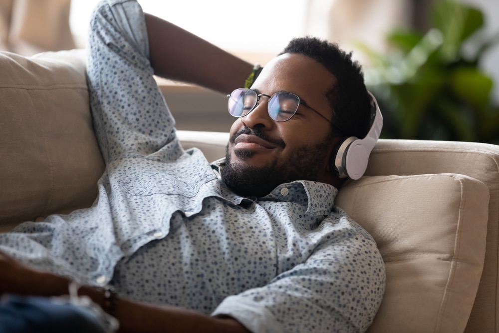 Patient listening to music and relaxing after comfortable Sedation Dentistry at Ackerman & Towson Dentistry