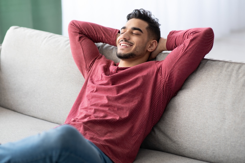 Man relaxing comfortably at home after Sedation Dentistry in Brentwood, CA