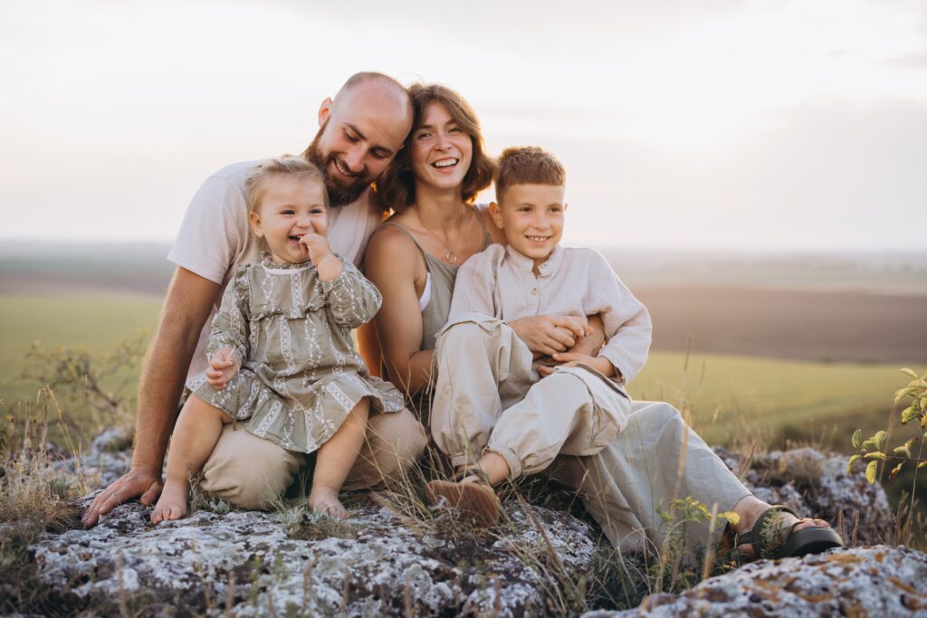 Happy family smiling outdoors after personalized family dental care in Brentwood