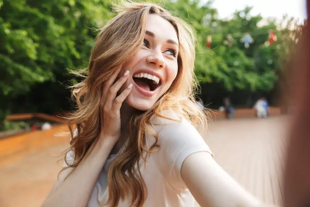 Young woman laughing with bright healthy smile after cosmetic dentistry treatment