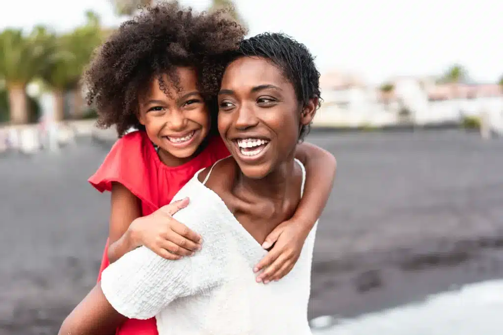 Mother and daughter smiling together with healthy smiles in Brentwood, CA