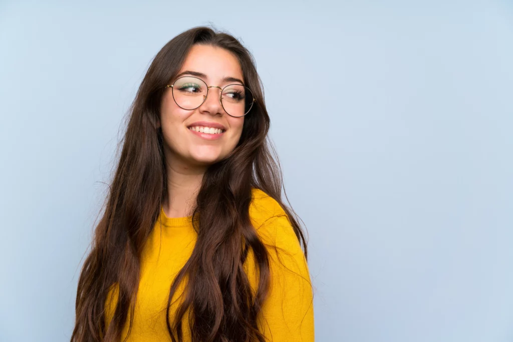 Young woman with bright confident smile after cosmetic dental care at Ackerman & Towson Dentistry