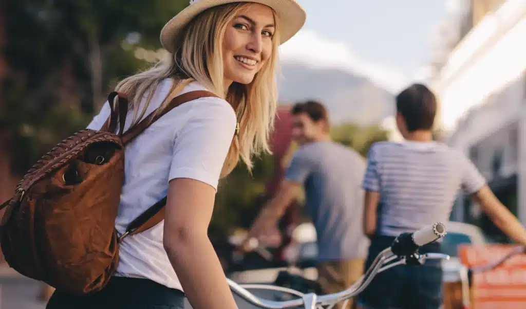 Young woman smiling confidently outdoors after cosmetic dental care in Brentwood