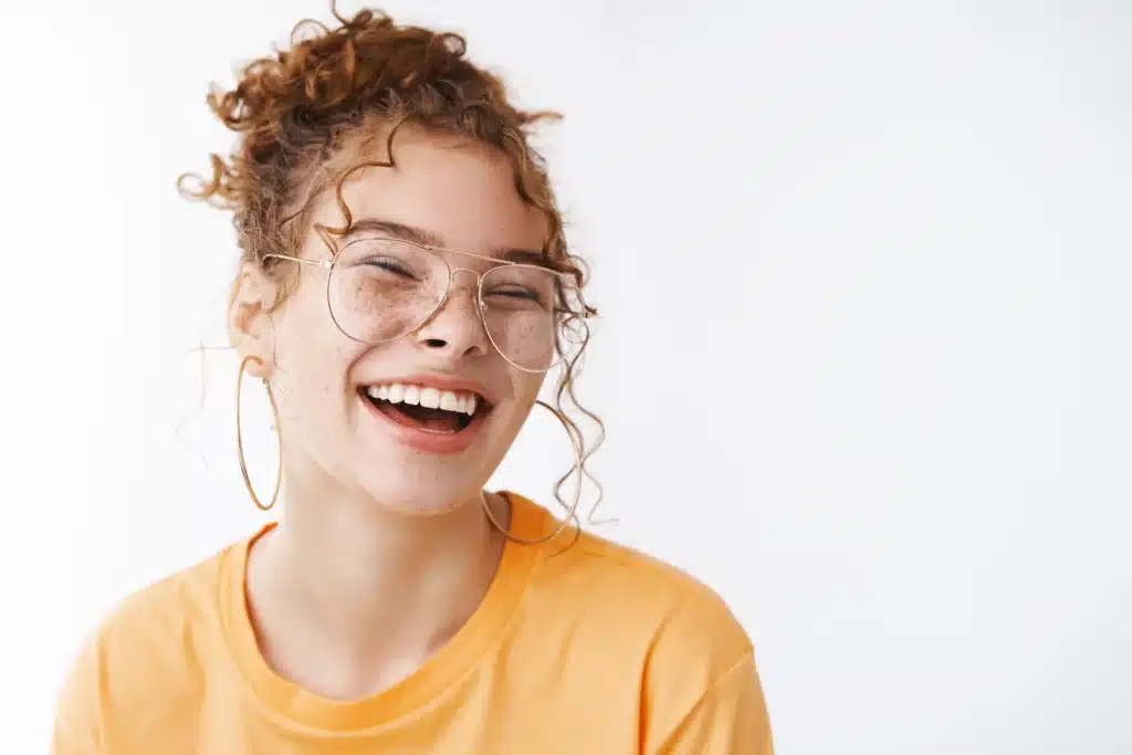 Woman with bright healthy smile after personalized dental treatment at Ackerman & Towson Dentistry